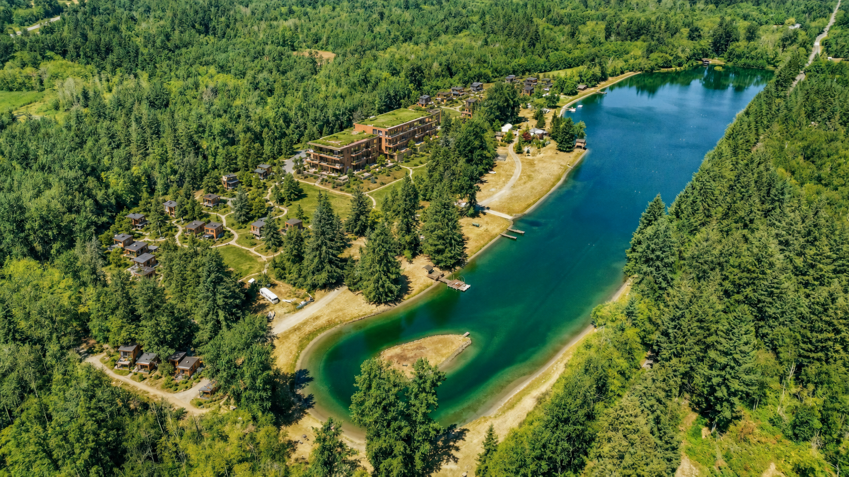 Conceptual aerial rendering preserving existing lakeside buildings while adding Lake Commons apartments, woodland homes and tiny-home hamlets